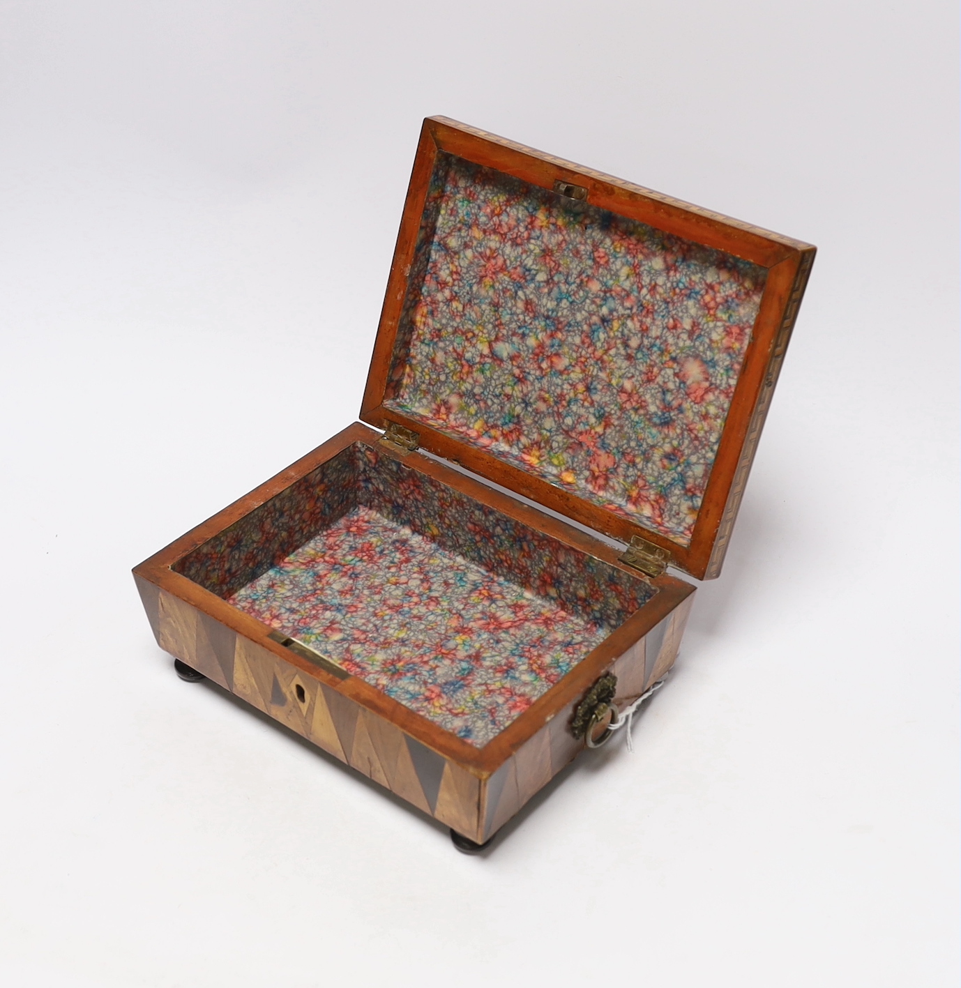 An early 19th century specimen wood, perspective cube marquetry box, 20.5cm wide, 9cm high, 15cm deep